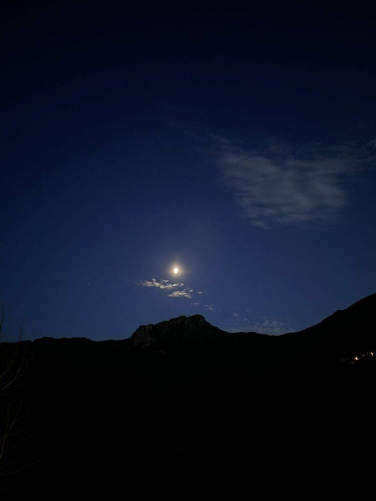 Night sky in Corsica with the moon over the mountains. July 2023.