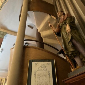 Stairs leading to the Organ in the church of Porto Vecchio. The statue next to it represents Saint Roch.